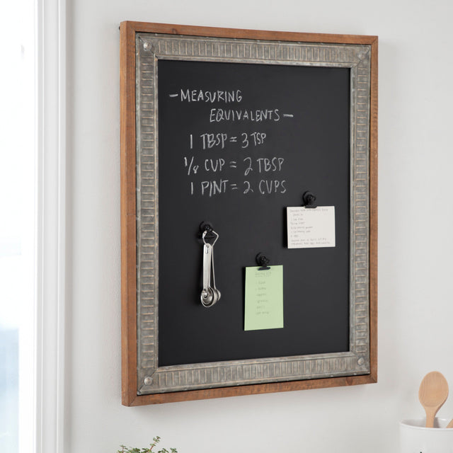 Chalkboard with measurements and notes on a wall in a kitchen setting