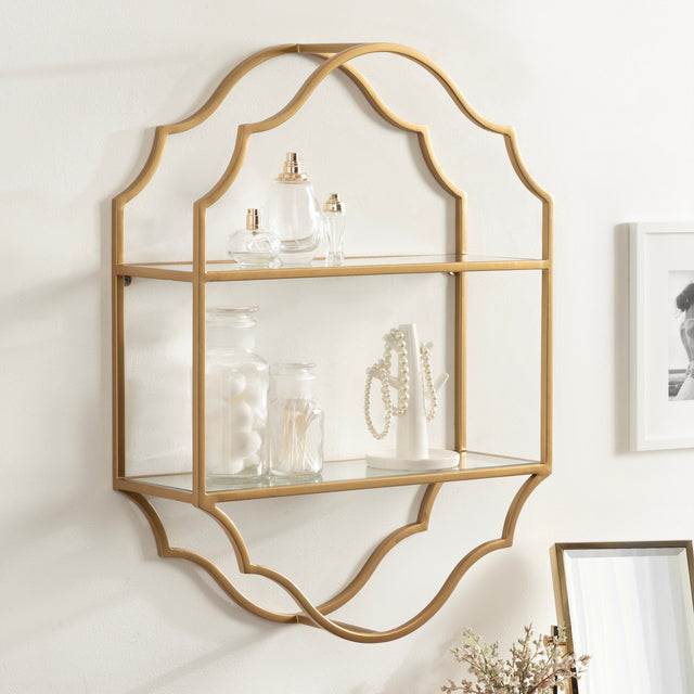 Gold wall shelf with glass panels on a white wall